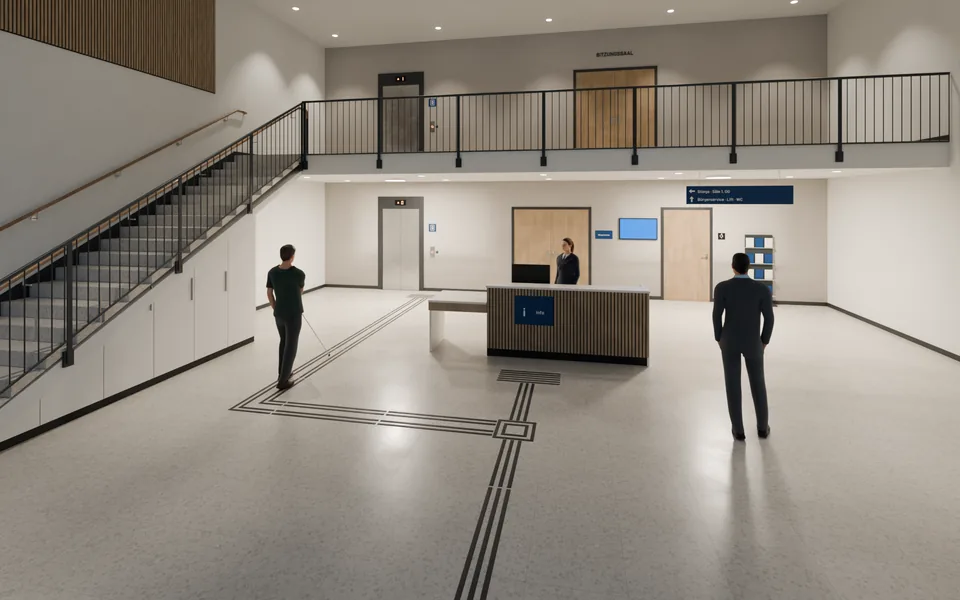 Beispielansicht: Foyer mit hellem Steinboden. Ein dunkler Leitstreifen führt von der Tür zum Empfang. An einer Abzweigung liegt ein quadratisches Feld, von dort führt ein zweiter Streifen zum Lift. Links die Stiege, rechts ein Wegweiser. Ein Besucher mit weißem Langstock folgt dem Streifen zum Lift.